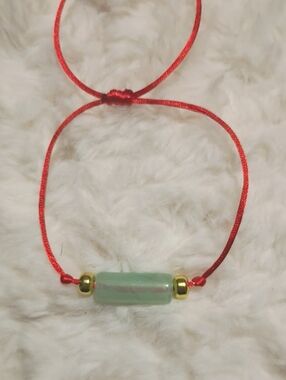 Adjustable Red Cord Bracelet with Light Green Bead and Gold Accents
